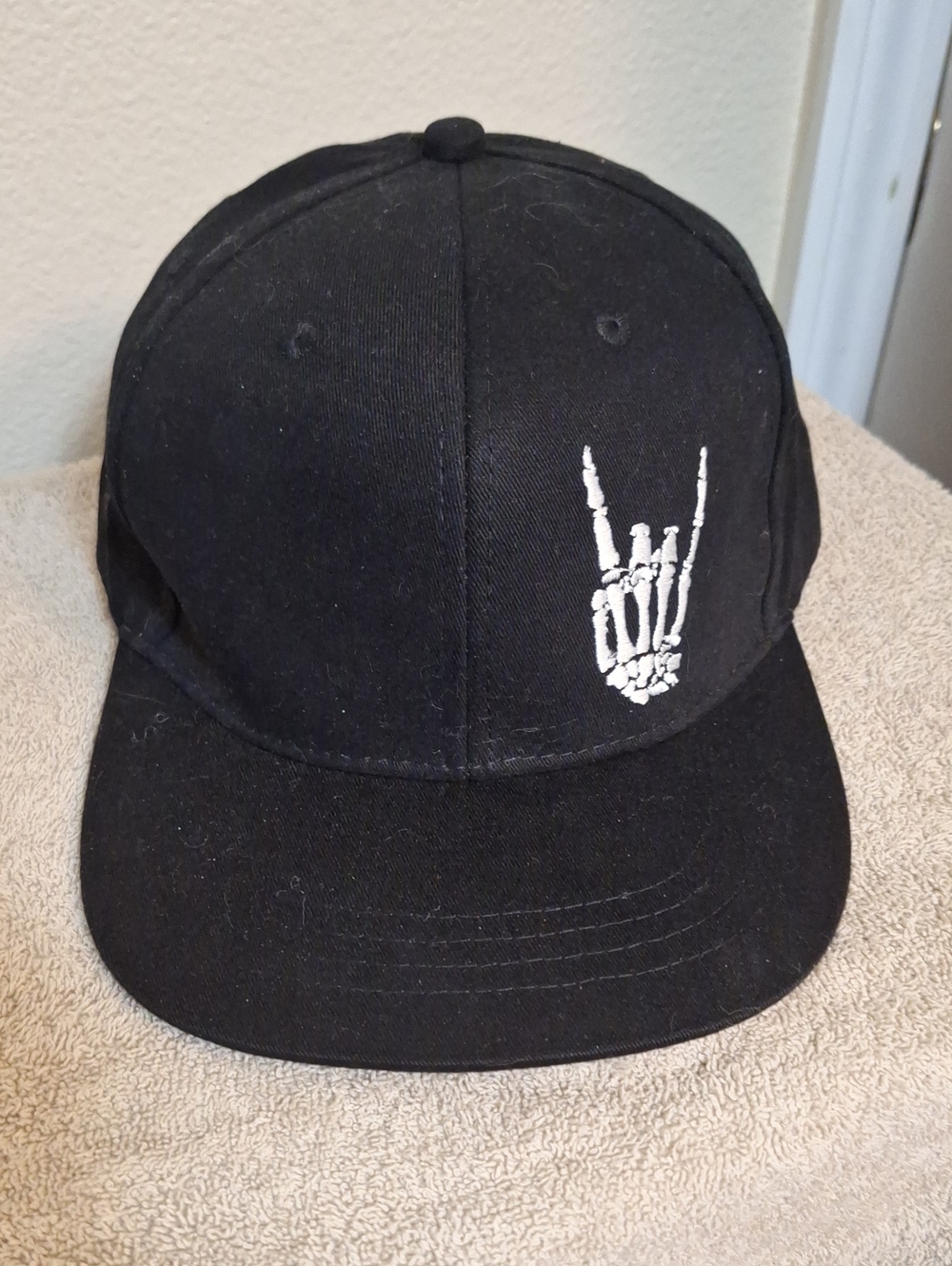 Black Snapback Hat with White Skeleton Hand Graphic
